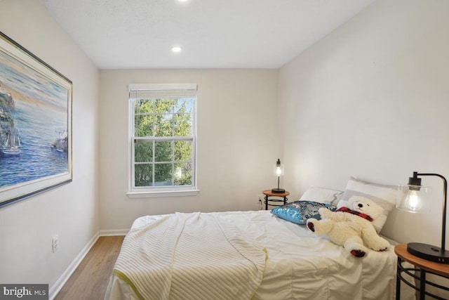 bedroom with hardwood / wood-style flooring