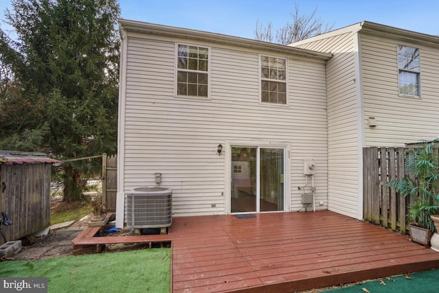 back of house with central AC and a deck