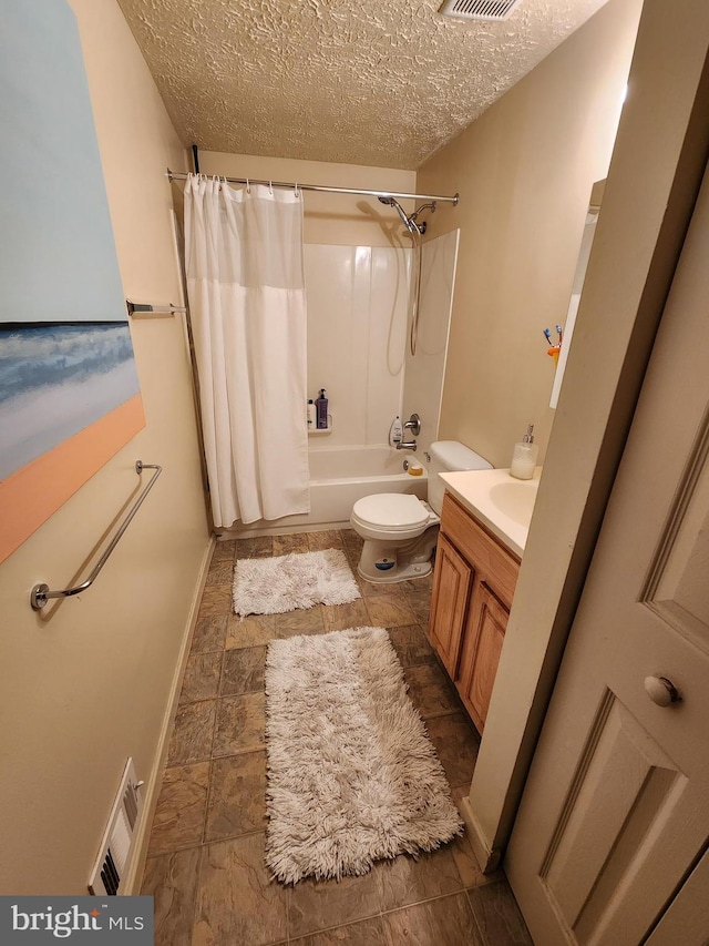 full bathroom with a textured ceiling, vanity, shower / tub combo, and toilet