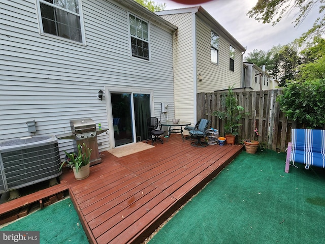 deck featuring central air condition unit and a grill