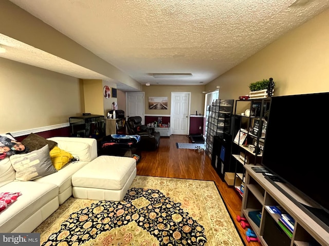 living room featuring wood finished floors and a textured ceiling