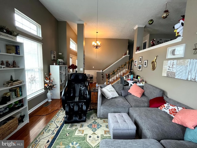 living room with hardwood / wood-style flooring, plenty of natural light, and a chandelier