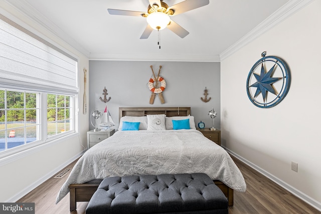 bedroom with ornamental molding, ceiling fan, and dark wood-type flooring