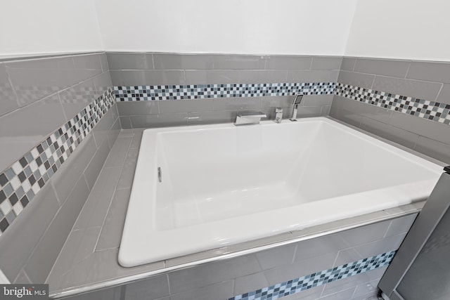 bathroom featuring a relaxing tiled tub