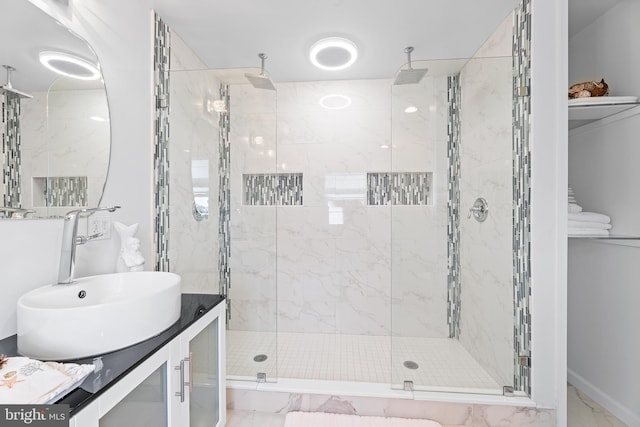 bathroom with vanity and a shower with shower door