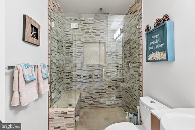 bathroom with toilet and a shower with shower door