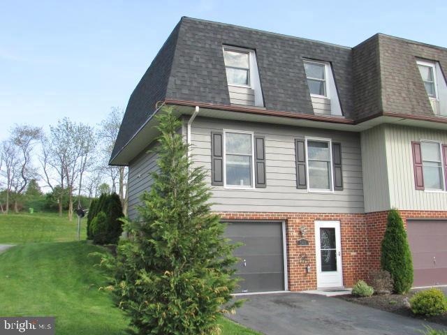 view of front of home with a garage and a front lawn