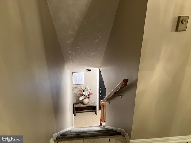 stairway featuring tile patterned flooring