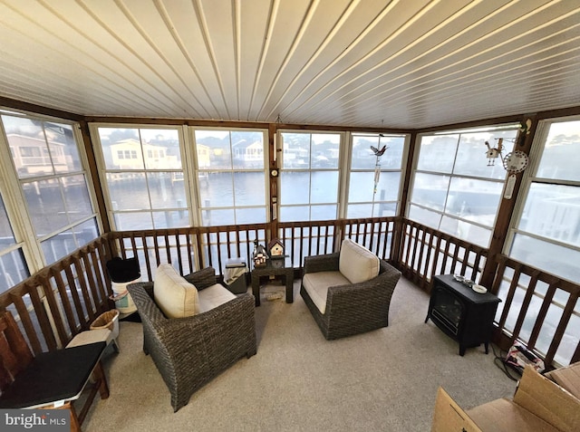 sunroom / solarium with a water view