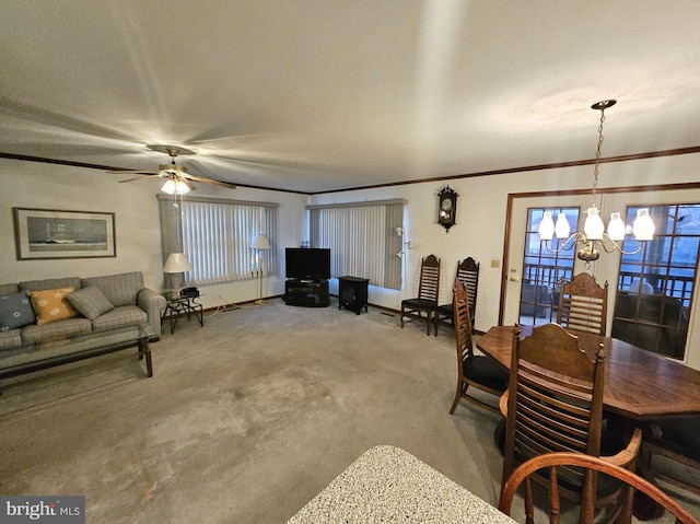 dining space featuring carpet, ceiling fan with notable chandelier, and crown molding