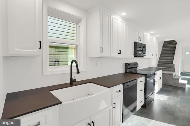 kitchen featuring sink, white cabinets, and black appliances