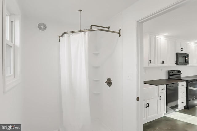 bathroom with a shower with curtain and concrete floors