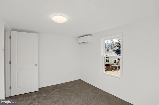 empty room with dark colored carpet and a wall unit AC