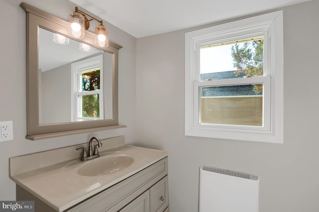 bathroom featuring radiator heating unit and vanity