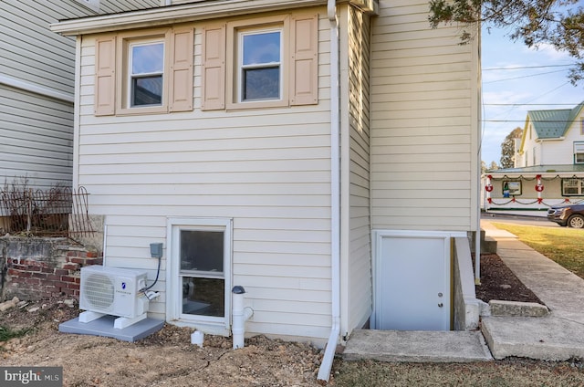 view of side of property with ac unit