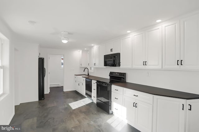 kitchen featuring black appliances, white cabinets, sink, and a baseboard heating unit