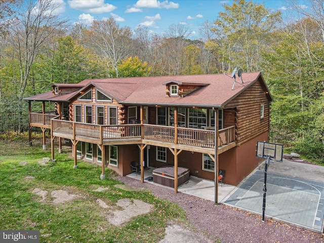 back of property with a deck and a patio area