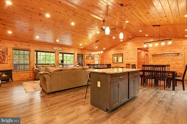 kitchen featuring wood ceiling, decorative light fixtures, and light hardwood / wood-style floors