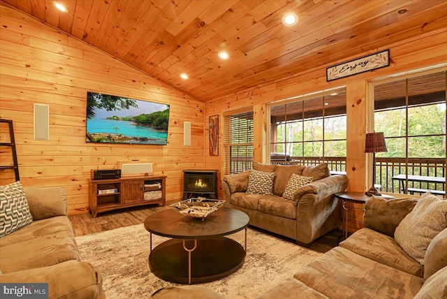 living room featuring wooden walls, wood ceiling, vaulted ceiling, and light wood-type flooring