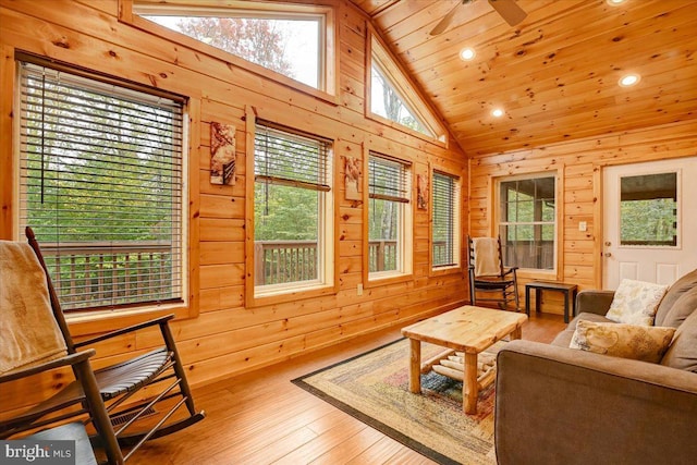 sunroom / solarium with wood ceiling, ceiling fan, a healthy amount of sunlight, and lofted ceiling