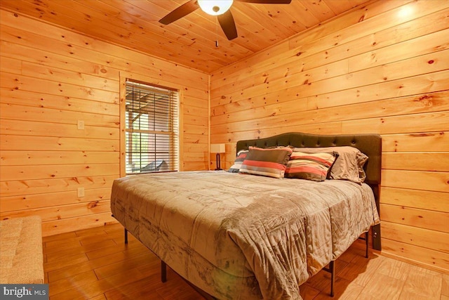 bedroom with ceiling fan, light wood-type flooring, wooden walls, and wooden ceiling