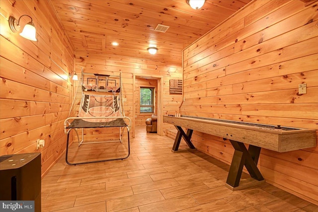 recreation room featuring wooden walls, wood ceiling, and light wood-type flooring