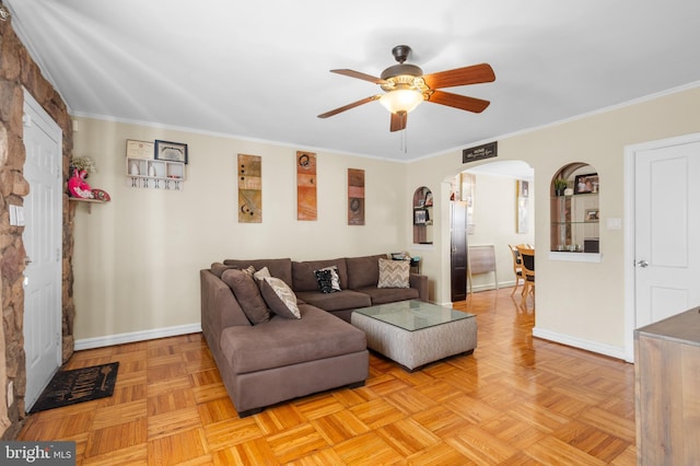 living room with light parquet flooring, ceiling fan, and crown molding