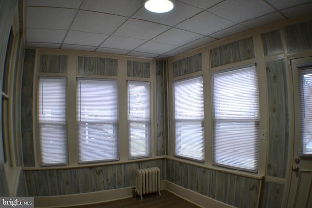 unfurnished sunroom with radiator heating unit