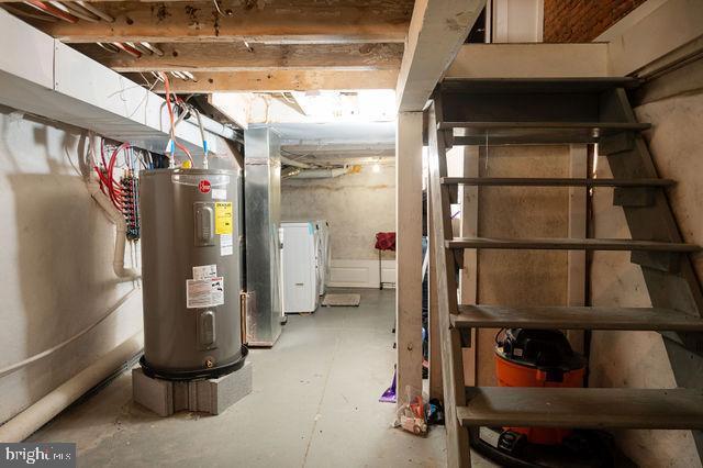 basement with electric water heater and washer / clothes dryer