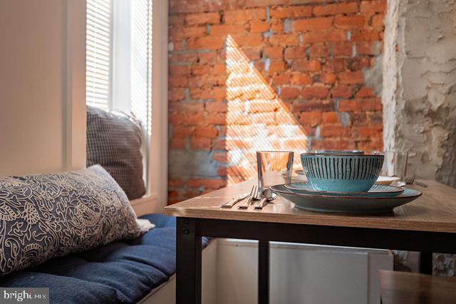 interior space featuring brick wall