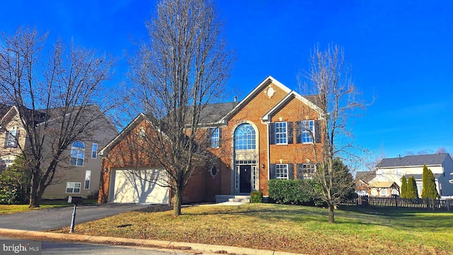 view of front of house with a front yard and a garage