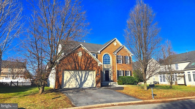 view of property featuring a garage and a front yard