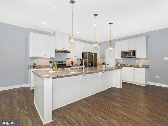 kitchen featuring white cabinetry, hanging light fixtures, an island with sink, and stainless steel appliances