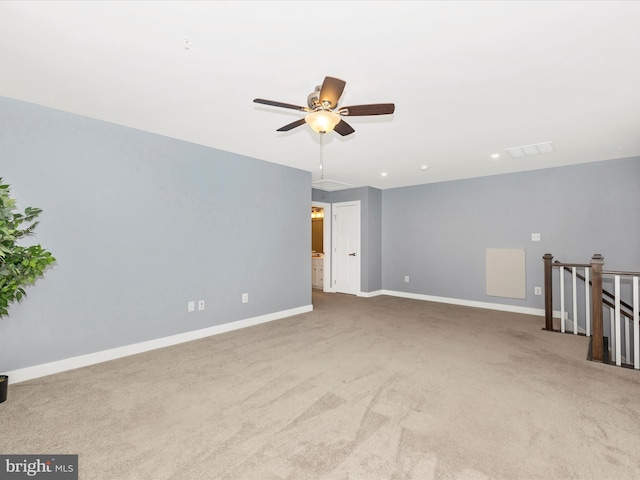 carpeted spare room with ceiling fan