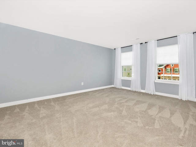 unfurnished room with light colored carpet