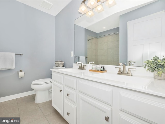 bathroom with tile patterned flooring, a tile shower, vanity, and toilet