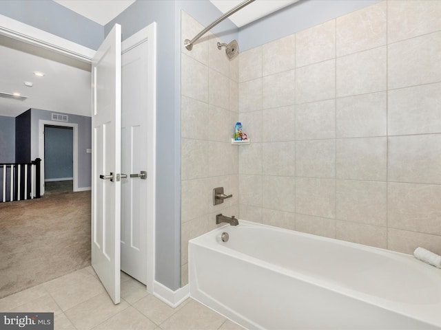 bathroom with tile patterned floors and tiled shower / bath combo