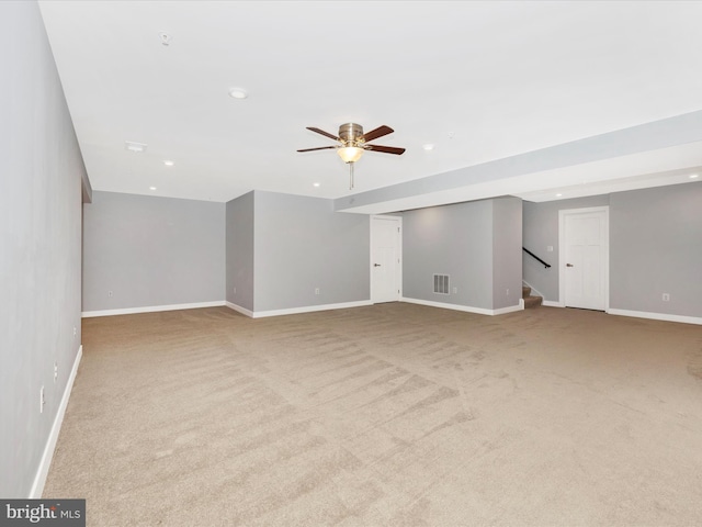 interior space with light colored carpet and ceiling fan