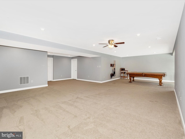 interior space featuring light colored carpet, ceiling fan, and pool table