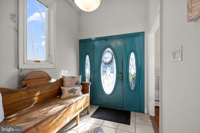 tiled entrance foyer with a baseboard heating unit