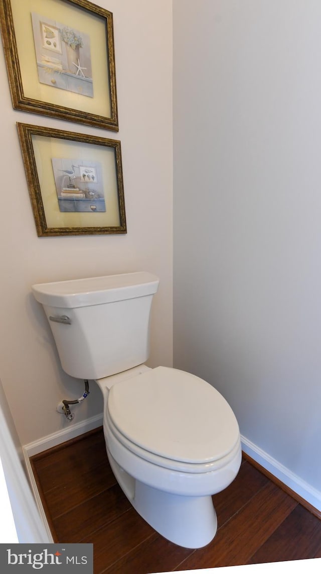 bathroom with hardwood / wood-style flooring and toilet