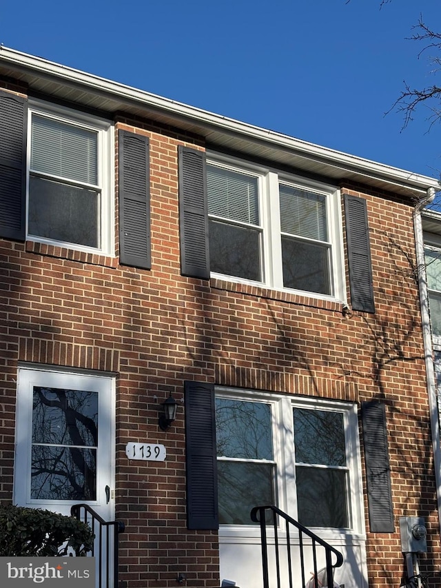 view of property with brick siding