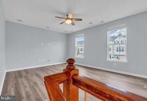 unfurnished room featuring hardwood / wood-style flooring and ceiling fan