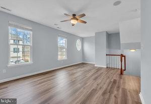 spare room featuring hardwood / wood-style floors, a wealth of natural light, and ceiling fan