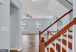 stairway featuring hardwood / wood-style floors and ceiling fan