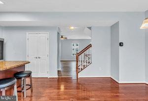 kitchen with dark hardwood / wood-style floors and a kitchen bar