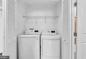 clothes washing area with washer and clothes dryer