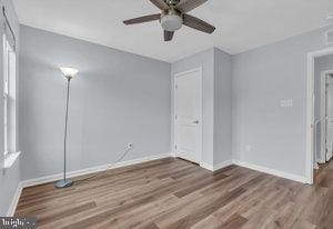 unfurnished room featuring hardwood / wood-style floors and ceiling fan