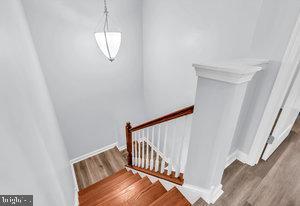 staircase featuring hardwood / wood-style flooring