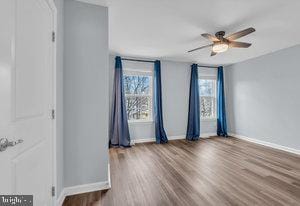 spare room with hardwood / wood-style flooring and ceiling fan